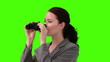 Woman looking at the landscape with a pair of binoculars