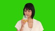 Nice asian woman is enjoying a glass of white wine