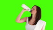 Brunette woman after sport drinking water