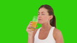 Cute brunette woman drinking orange juice