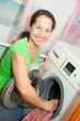 Mature woman with washing machine