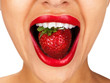 Closeup of a young girl mouth with a strawberry