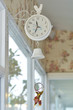 Cute white hanging clock decorated in coffee shop