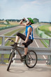 Photo: Mountain biker drinking isotonic drink and having rest Mountain biker drinking isotonic drink and having rest