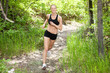 Photo: Woman smiling and running in forest Woman smiling and running in forest