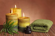 Foto: Spa products with green candles, stones and towel Spa products with green candles, stones and towel