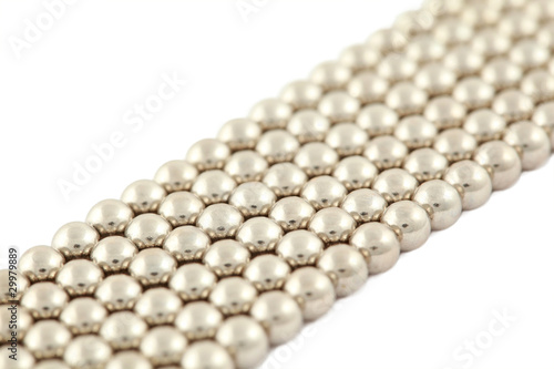 Photo: Bar which lies bias consisting of silvery beads on white Bar which lies bias consisting of silvery beads on white
