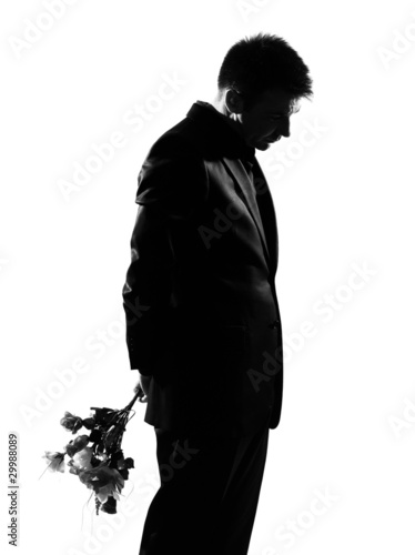 Photo: silhouette man offering flowers silhouette man offering flowers