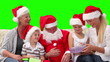 Santa Claus offering gifts to a family