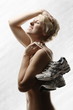 Young, beautiful woman with running shoes