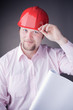 Young Engineer with blueprints raises his hat Young Engineer with blueprints raises his hat