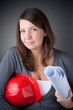 Portrait of young architect wearing red hardhat, looking at came Portrait of young architect wearing red hardhat, looking at came