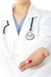 Doctor with lab coat holding pill