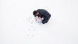 Businessman searching wastebasket with crumpled paper