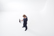 Standing businessman using laptop