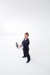 Foto: Standing businessman using laptop Standing businessman using laptop