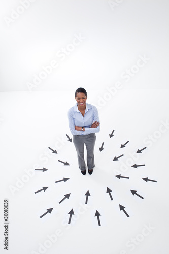 Photo: Businesswoman surrounded by arrows Businesswoman surrounded by arrows