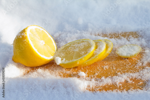 Photo: The cooled lemon among ice close up The cooled lemon among ice close up