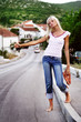 Beautiful young woman hippie posing over picturesque landscape.