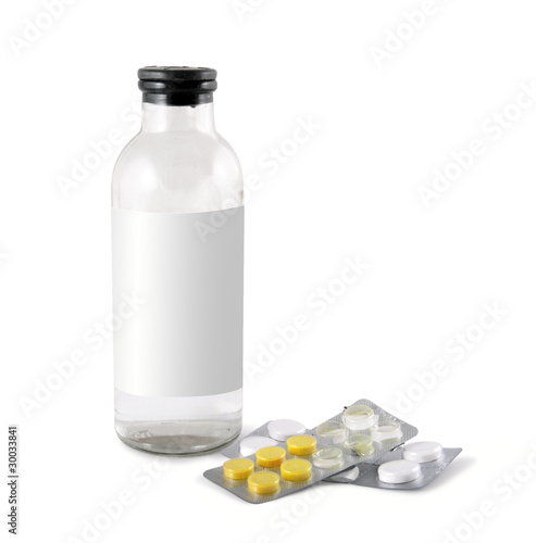 Photo: Medical glass bottle and packing tablets isolated on white Medical glass bottle and packing tablets isolated on white