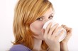 Young woman with a coffee mug (white background) Young woman with a coffee mug (white background)