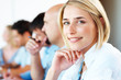 Happy young business woman with colleagues at a conference