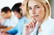 Thoughtful young business woman in a meeting with colleagues Thoughtful young business woman in a meeting with colleagues
