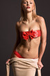 Sexy blonde woman taking off clothes