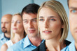 Confident business people standing in a row looking away