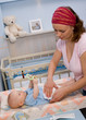 mother changing baby's diaper
