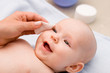 cleaning baby 's eye with cotton pad