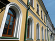 old yellow building with green storm-down pipe