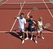happy young couple play tennis game outdoor