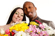 Young newly weds looking over larger bunch of colourful flowers