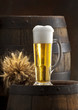glass of beer on old barrel
