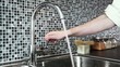 Washing hands in modern kitchen