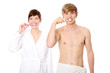 Young couple cleaning teeth together.