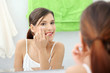 Beautiful woman applying cream on face Beautiful woman applying cream on face