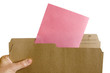 Hand holding file folder with Pink Slip Layoff Notice
