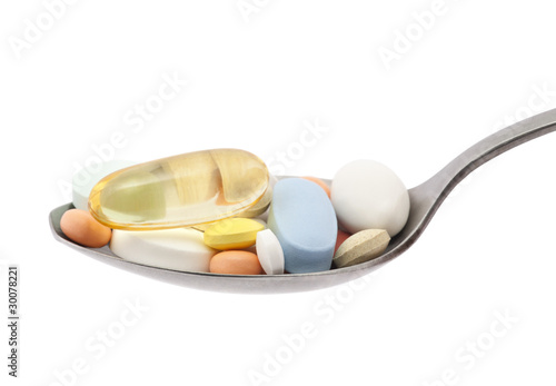 Photo: Pills on spoon with clipping path Pills on spoon with clipping path