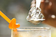 Spoon up sparkling ice cube by hand Spoon up sparkling ice cube by hand