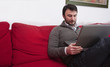 Photo: Portrait of a Relaxed Young Adult Using Laptop at Home Portrait of a Relaxed Young Adult Using Laptop at Home