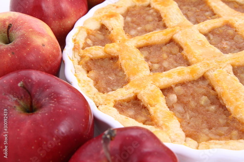 Photo: Apple Pie and some red apples on white background Apple Pie and some red apples on white background
