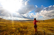 Greeting the sun, women on meadow and cloudy sky Greeting the sun, women on meadow and cloudy sky