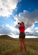 Foto: Nature photographer girl taking picture on natural background Nature photographer girl taking picture on natural background