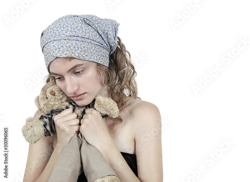 Photo: Sad teen holding old toy Sad teen holding old toy