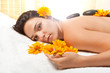 Woman getting a hot stone massage at spa salon