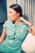 Portrait of beautiful brunette in a stylish fashion dress