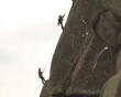 Tether climber mounted on top of cliff.