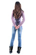 Beautiful young woman looking at wall. Rear view.